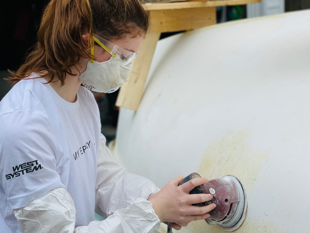 West System Employee prepares a surface for epoxy use