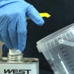 West System Epoxy being applied to measuring container